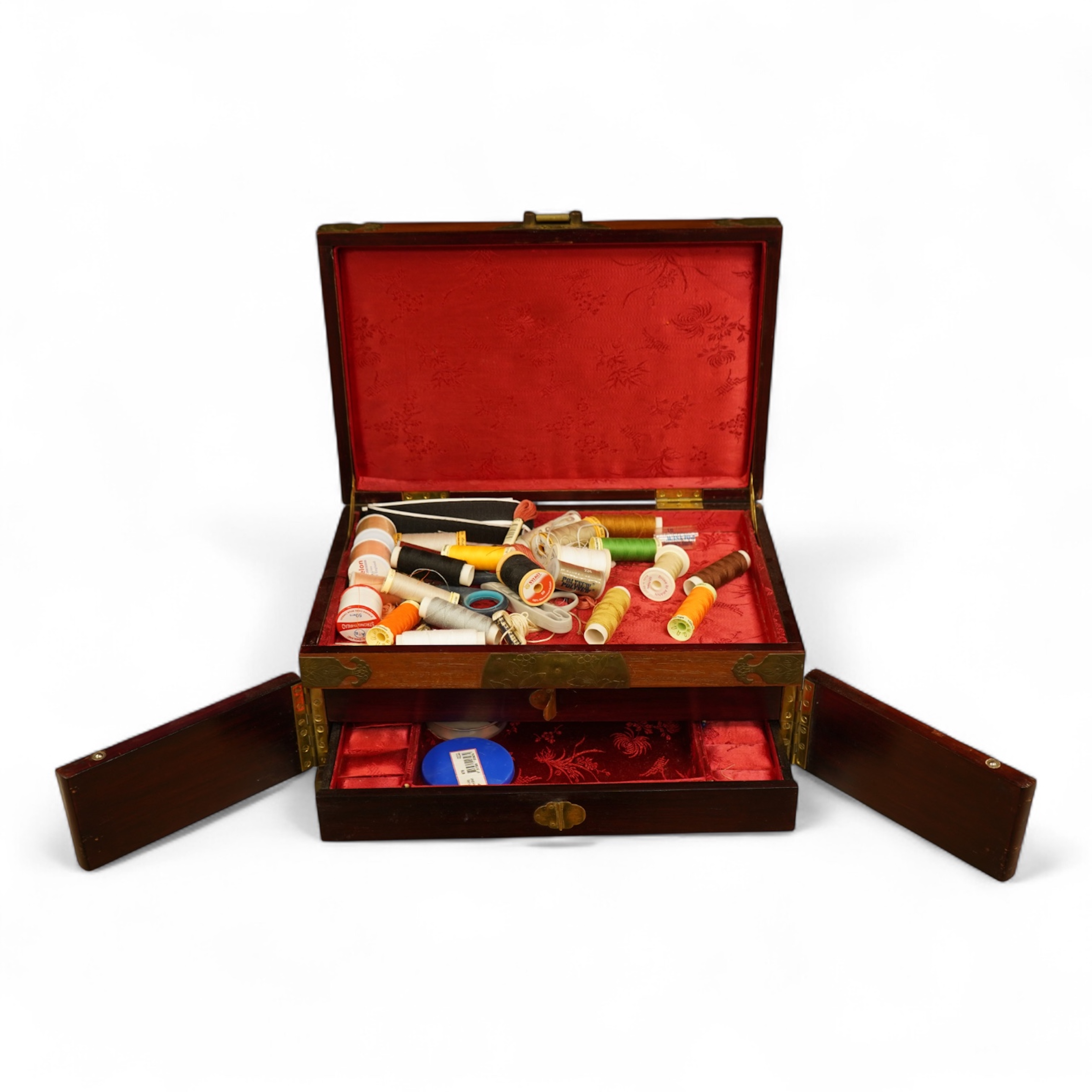 A Chinese brass bound rosewood jewellery box with twin handles, the interior with sewing accessories and threads, 35cm wide